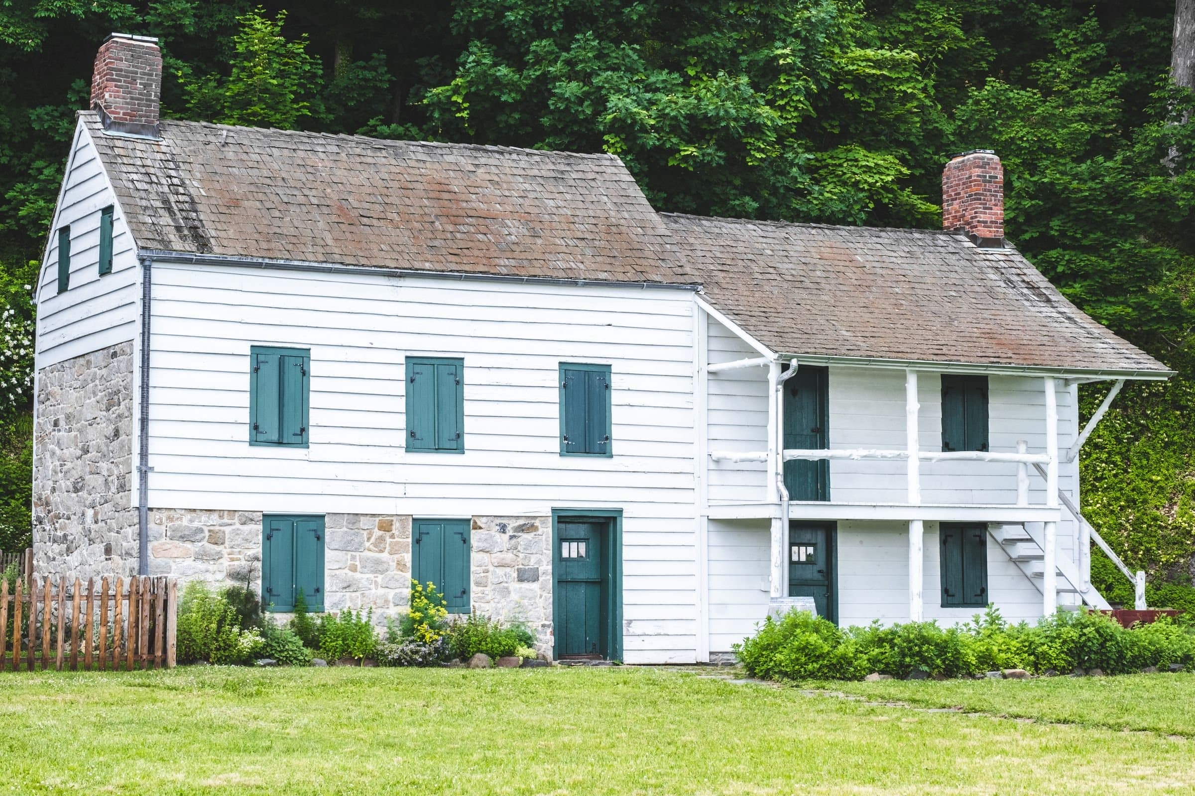 Fairfield, CT: a historic white clapboard and fieldstone colonial house on a green lawn