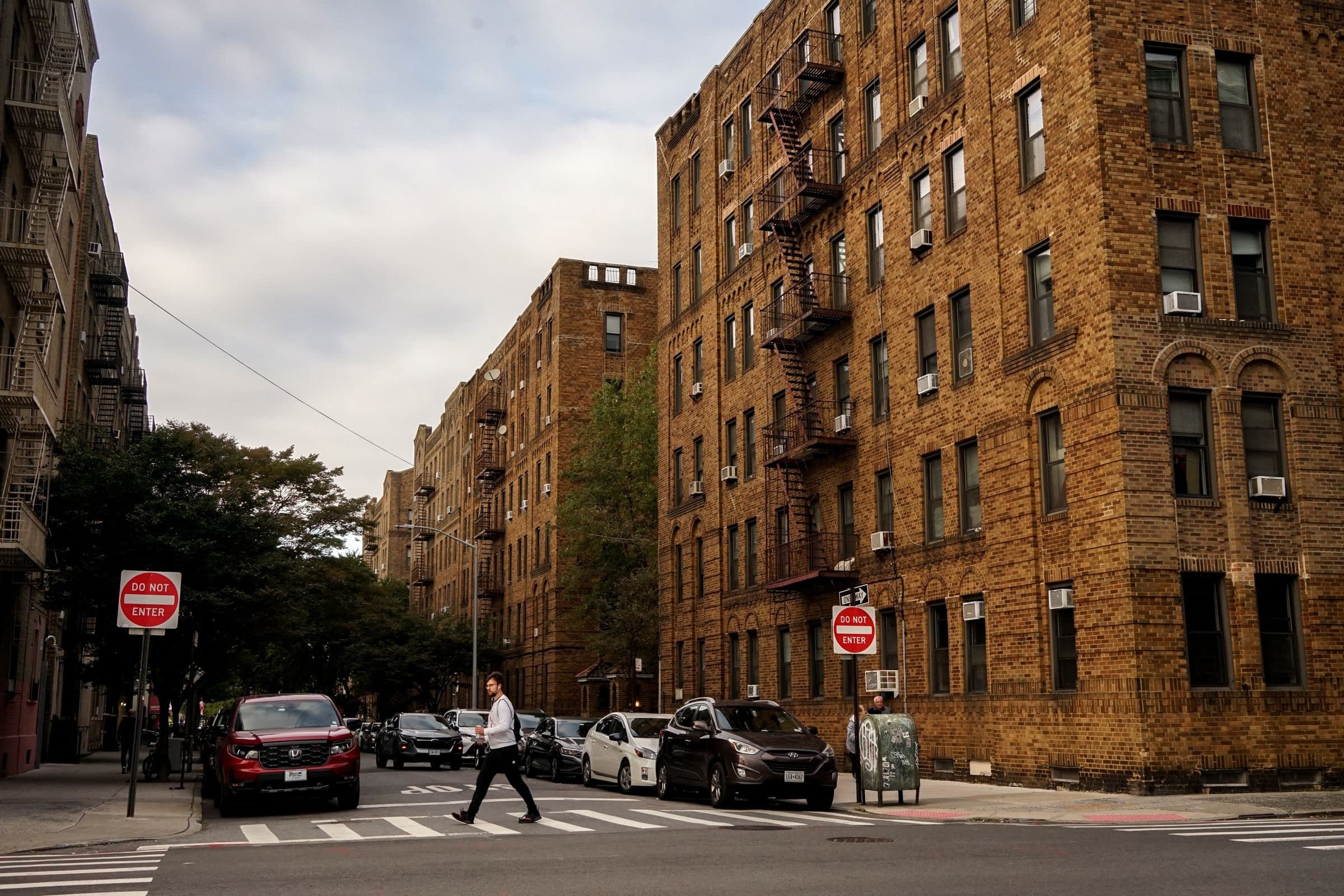 Port Chester, NY: brick apartment buildings on a street corner with parked cars
